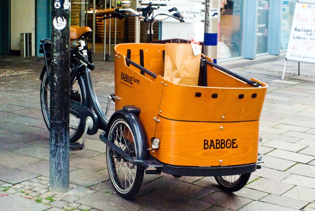 Paderborn is known for its many shopping boutiques. Here, a mother parks her bicycle cart to pick up some shopping.